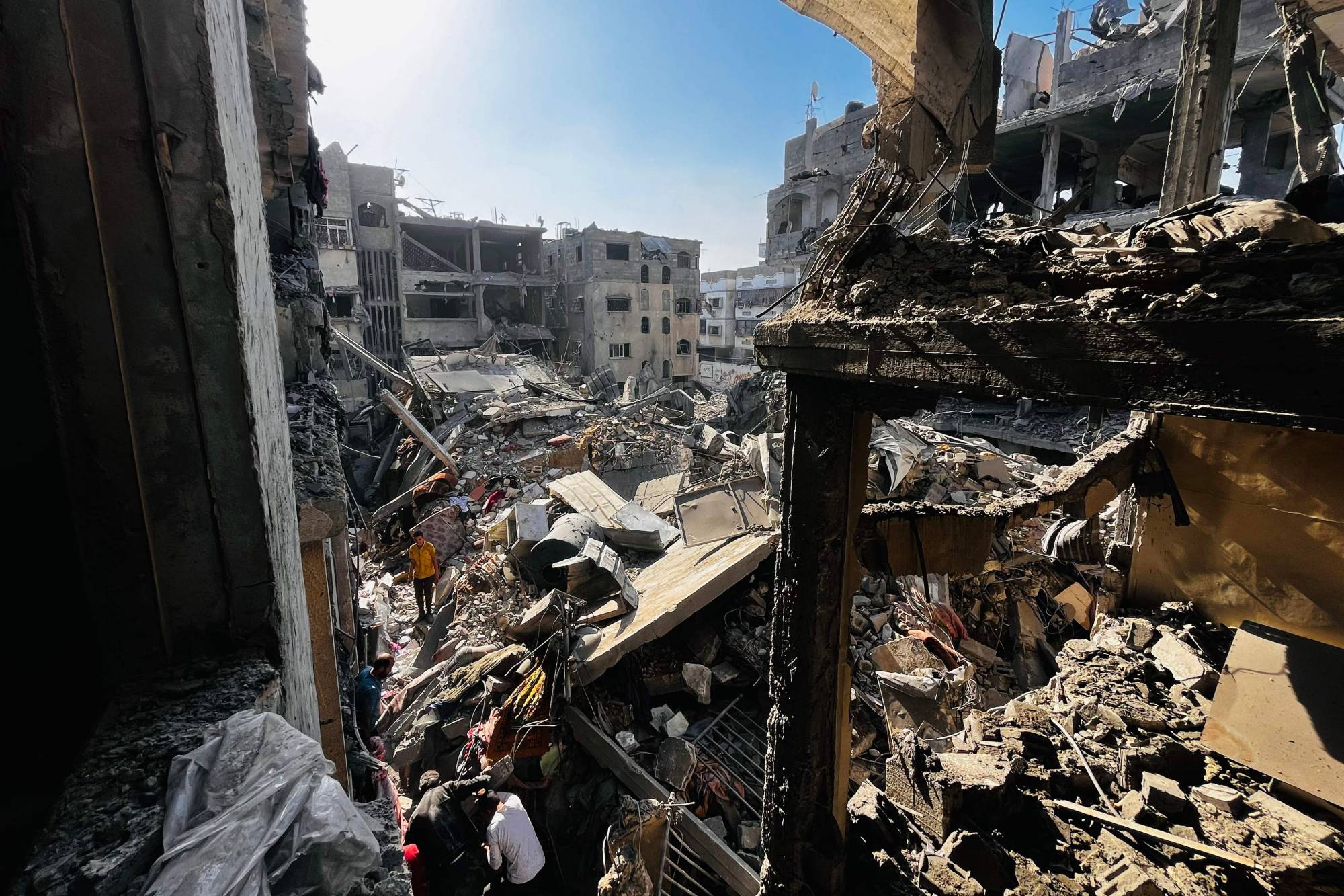 Palestinians search throught the rubble of a building after an Israeli strike in Beit Lahia, in the northern Gaza Strip, on October 29, 2024, amid the ongoing war in the Palestinian territory between Israel and Hamas. Gaza's civil defence agency said on October 29, that an overnight Israeli air strike killed more than 55 people in a residential building in the northern district of Beit Lahia. (Photo by AFP)